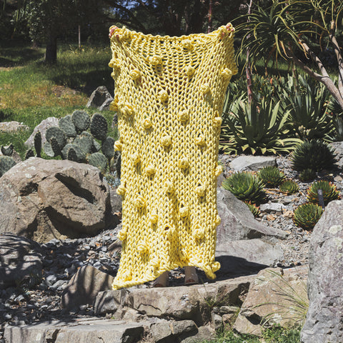 Create this chunky arm knitted blanket. We used chunky wool merino bumps of Plump & Co 2 ply yellow yarn, with Giant 45mm Needles from Plump & Co. In New Zealand and Australia. With chunky wool merino knits and layers of textures for your home inspiration.