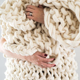 Plump & co chunky knit blanket in white giant yarn 1 ply made of felted New Zealand merino bulky wool using extreme knitting needles, XXL knitting and giant crochet hooks, Individual bumps, ottomans, giant weaving, cushions, wall hangings, key rings, and extreme knitting kits available. Worldwide shipping to USA, Canada, UK, Australia, Texas, New Zealand, Japan, Korea 