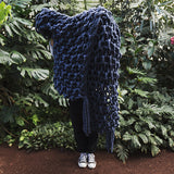 Create this chunky arm knitted blanket using the moss stitch. We used five chunky wool merino bumps of Plump & co 2 ply blue/indigo yarn, with Giant 45mm Needles from Plump & Co. in New Zealand and Australia. With chunky wool merino knits and layers of textures for your home inspiration.