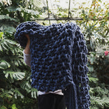 Create this chunky arm knitted blanket using the moss stitch. We used five chunky wool merino bumps of Plump & co 2 ply blue/indigo yarn, with Giant 45mm Needles from Plump & Co. in New Zealand and Australia. With chunky wool merino knits and layers of textures for your home inspiration.