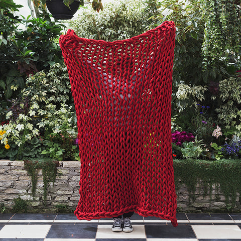 Plump & Co chunky knit blanket in red giant yarn 1 ply made of felted New Zealand merino bulky wool using extreme knitting needles, XXL knitting and giant crochet hooks, Individual bumps, ottomans, giant weaving, cushions, wall hangings, key rings, and extreme knitting kits available. Worldwide shipping to USA, Canada, UK, Australia, Texas, New Zealand, Japan, Korea 